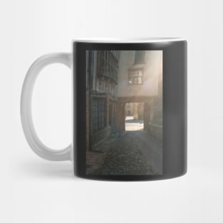 Medieval courtyard in Norwich bathed in sunlight Mug